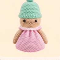 Crochet doll with mint hat and pink dress